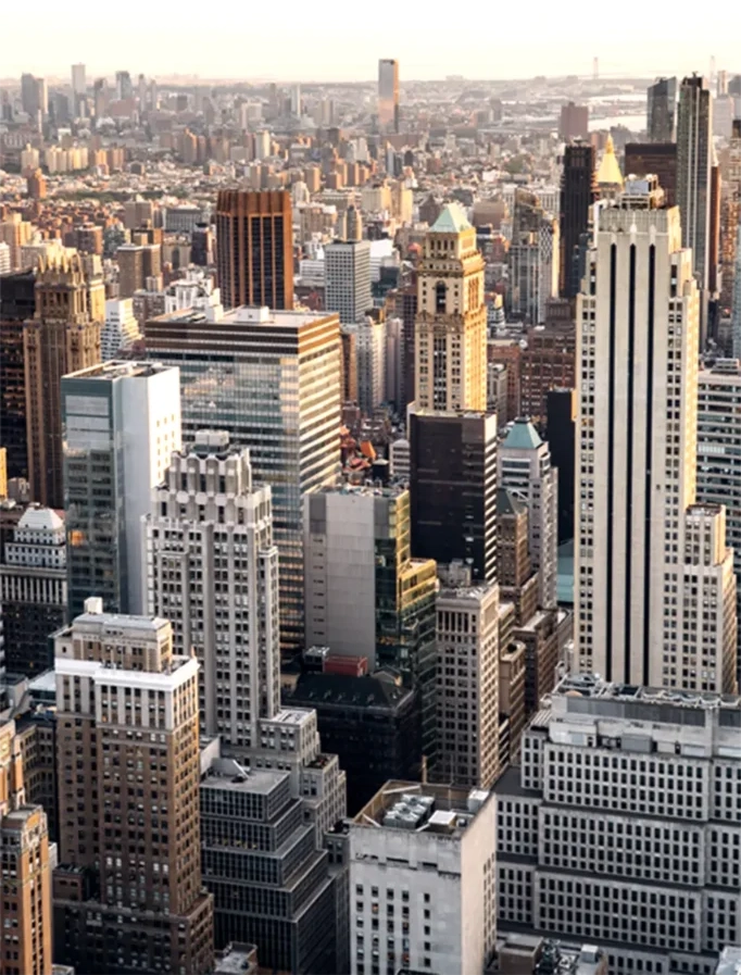 Aerial view of Manhattan’s iconic skyline at sunset — capturing the energy, prestige, and high-value real estate market of New York City that Dee Dee Abdur-Rahim specializes in.